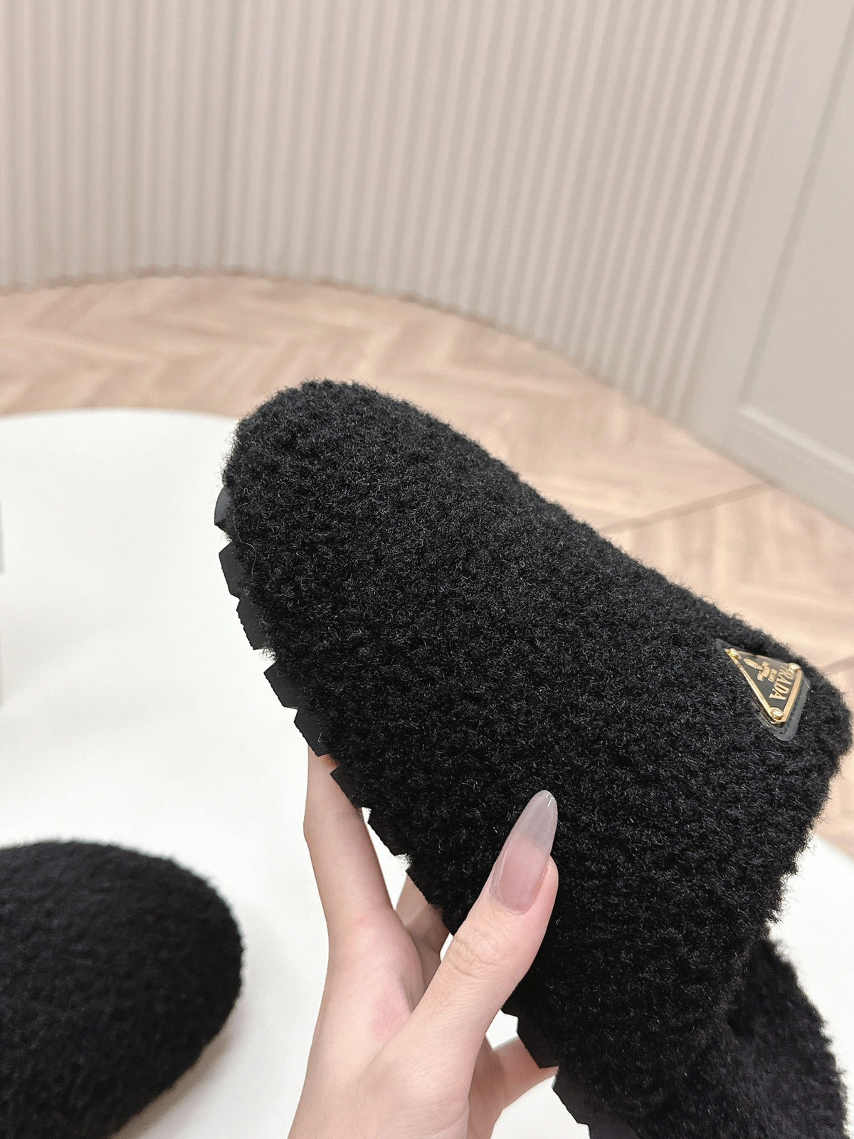 PRADA MULES ATTACHED TRIANGLE LOGO IN BLACK SHEARLING