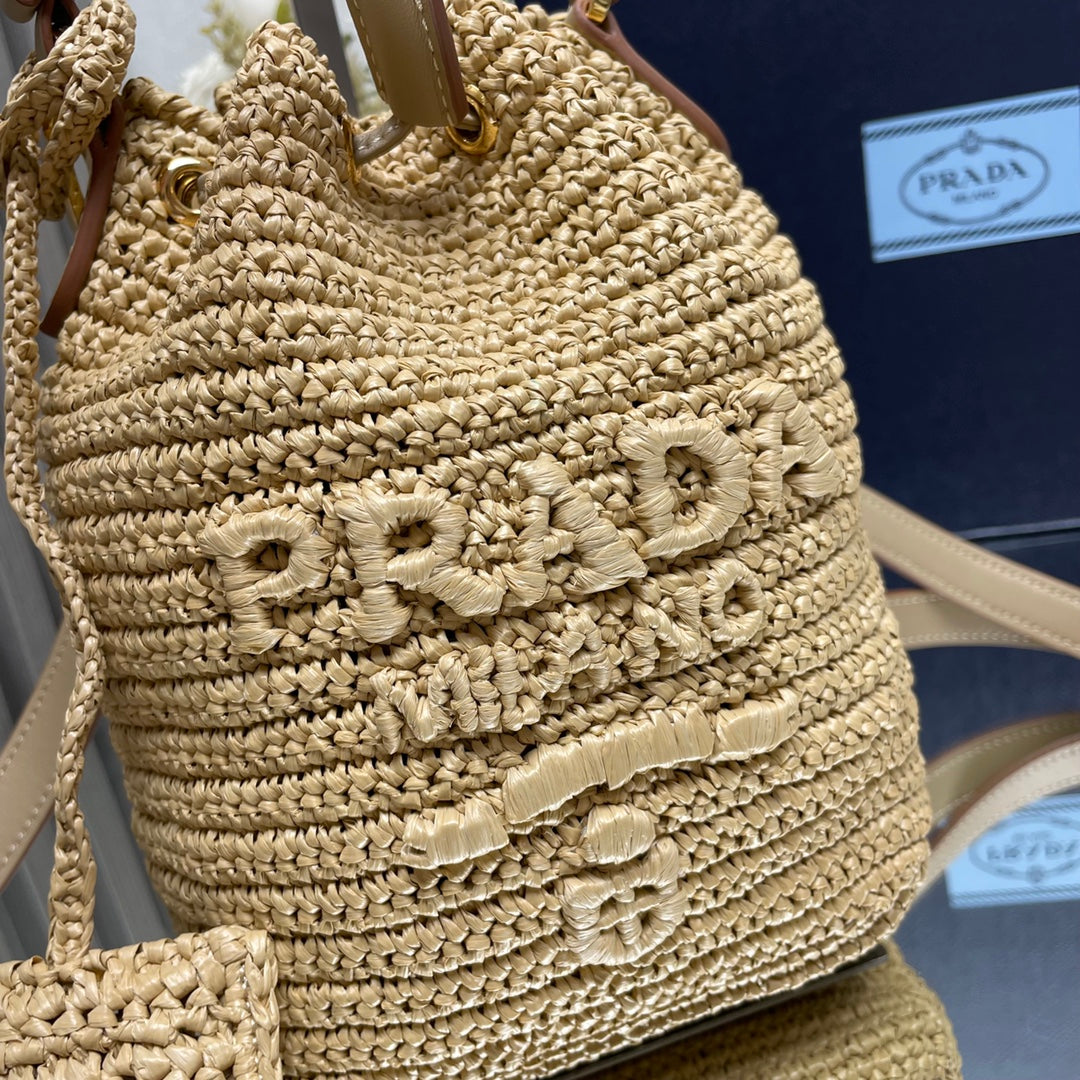PRADA BUCKET BAG 20 IN BEIGE WOVEN RAFFIA EMBOSSED LOGO