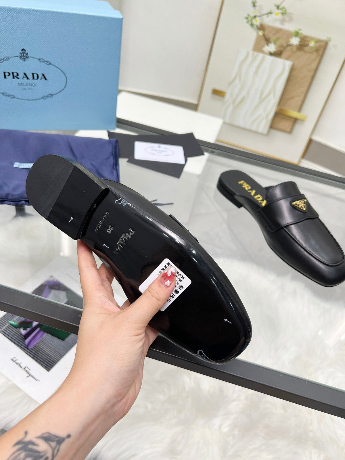 PRADA TRIANGLE LOGO MULES IN BLACK CALFSKIN