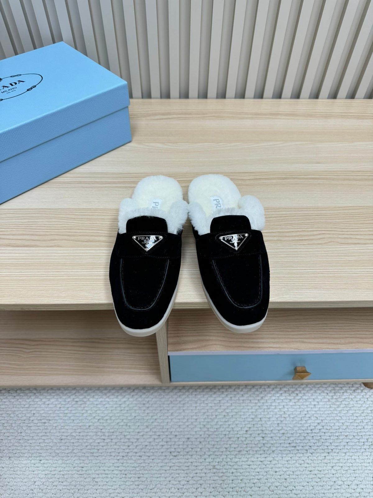 PRADA TRIANGLE LOGO FLATS IN BLACK SUEDE AND FUR LINING