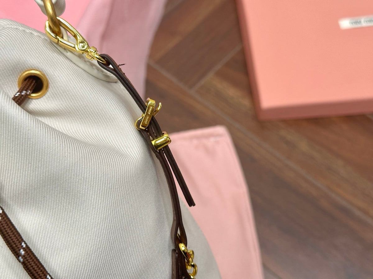 MIU MIU DRAWSTRING BUCKET BAG 21 IN WHITE CANVAS GOLD HARDWARE