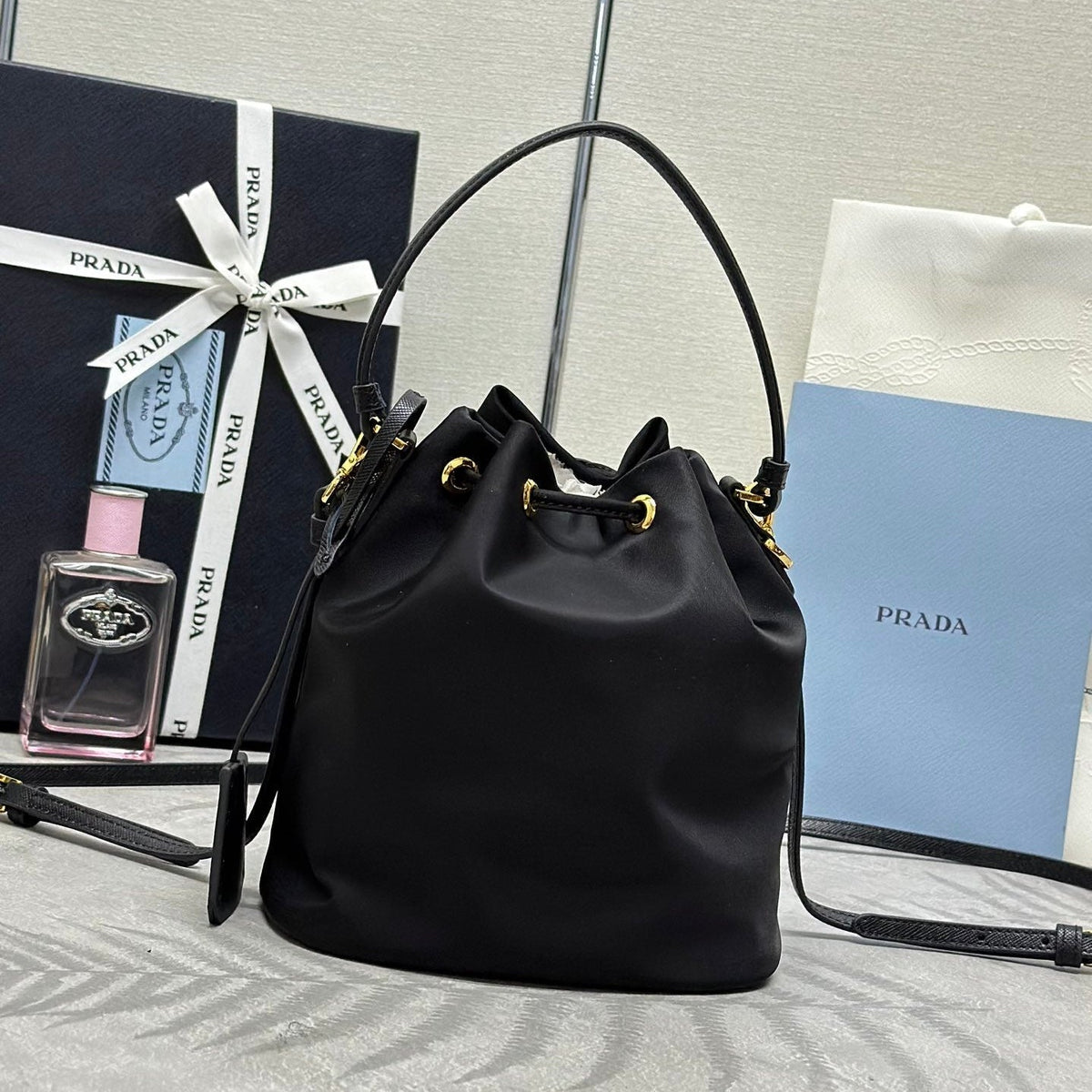 PRADA BUCKET BAG 19 IN BLACK RE-NYLON AND CALFSKIN HANDLE