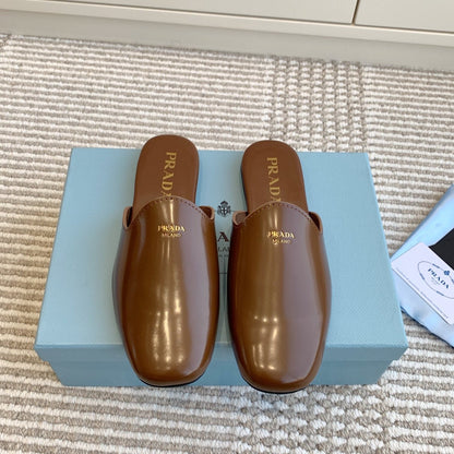 PRADA MULES IN BROWN GLOSSY SHEEPSKIN GOLD LETTERING LOGO