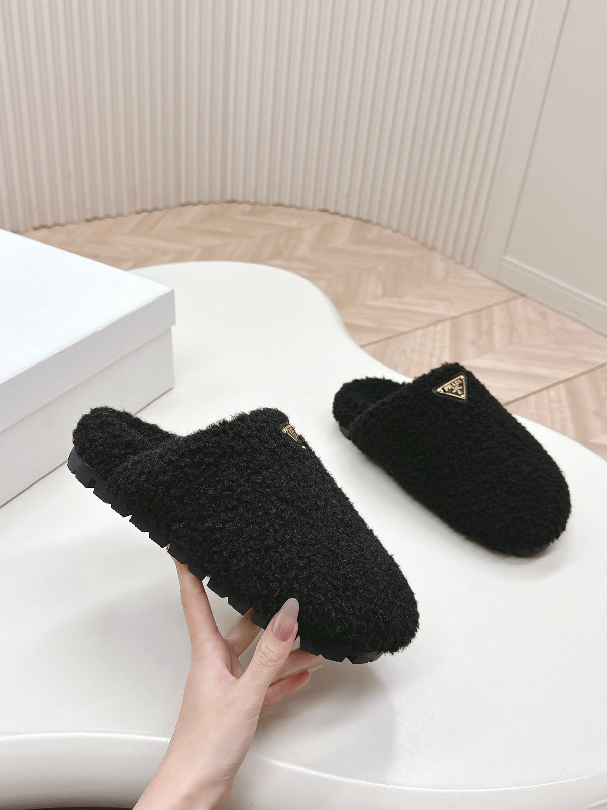 PRADA MULES ATTACHED TRIANGLE LOGO IN BLACK SHEARLING
