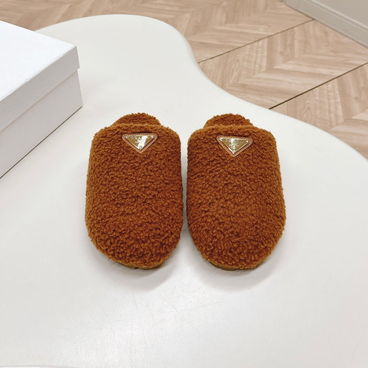 PRADA MULES ATTACHED TRIANGLE LOGO IN BRONZE BROWN SHEARLING