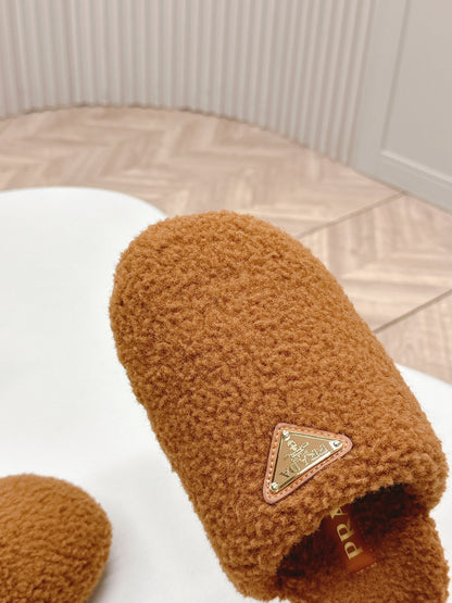 PRADA MULES ATTACHED TRIANGLE LOGO IN BRONZE BROWN SHEARLING