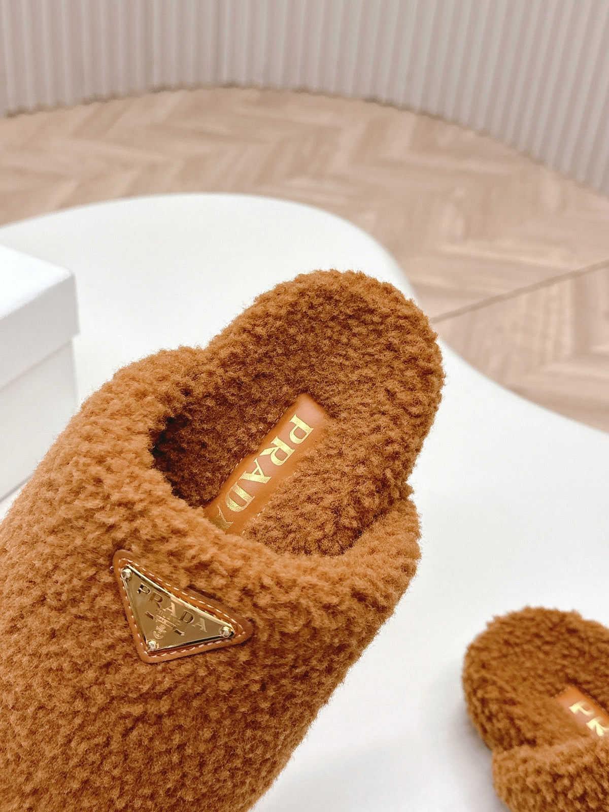 PRADA MULES ATTACHED TRIANGLE LOGO IN BRONZE BROWN SHEARLING