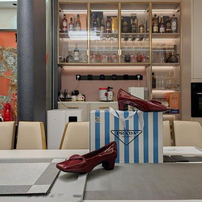 PRADA TRIANGLE LOGO PUMPS IN CURRANT RED GLOSSY CALFSKIN