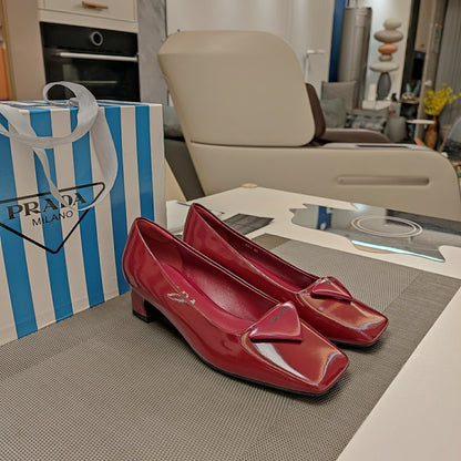 PRADA TRIANGLE LOGO PUMPS IN CURRANT RED GLOSSY CALFSKIN