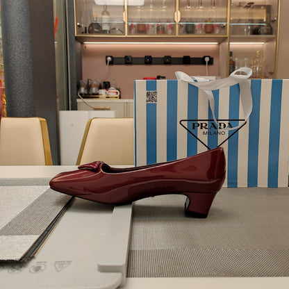 PRADA TRIANGLE LOGO PUMPS IN CURRANT RED GLOSSY CALFSKIN