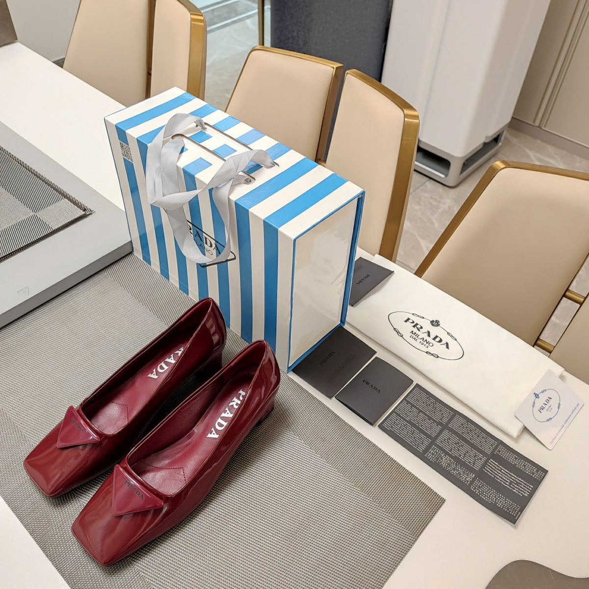 PRADA TRIANGLE LOGO PUMPS IN CURRANT RED GLOSSY CALFSKIN
