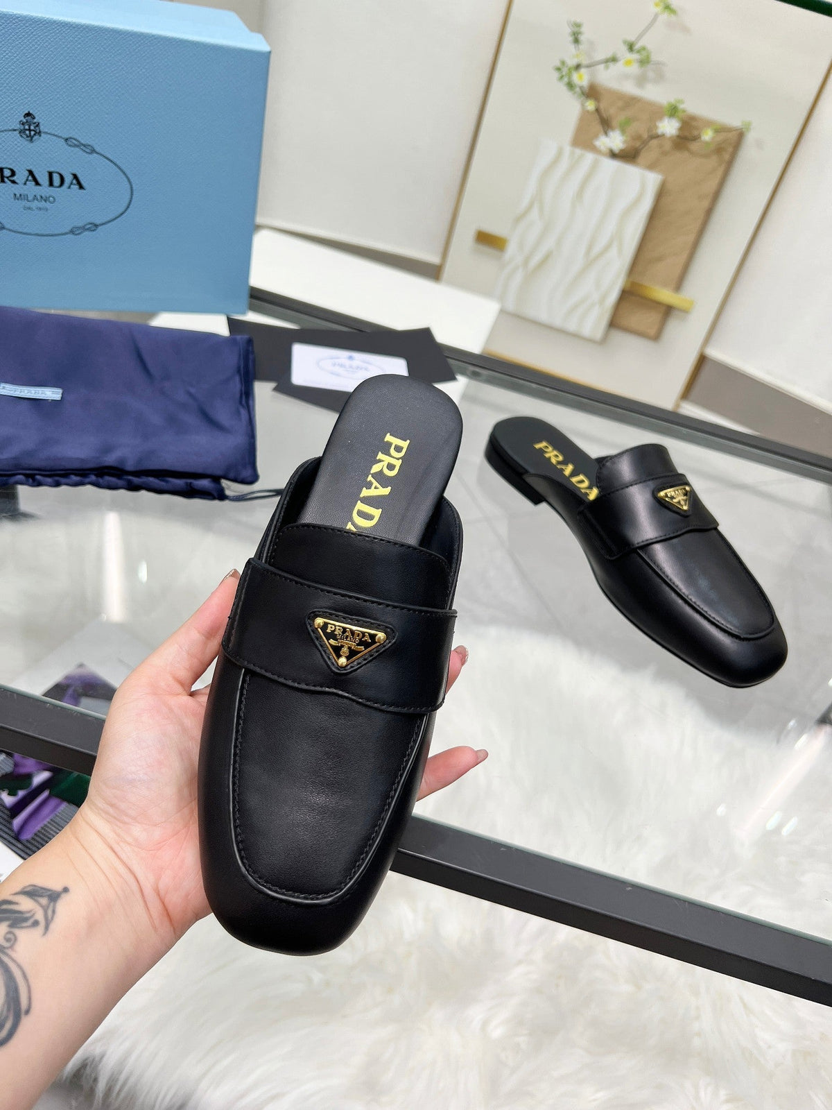 PRADA TRIANGLE LOGO MULES IN BLACK CALFSKIN