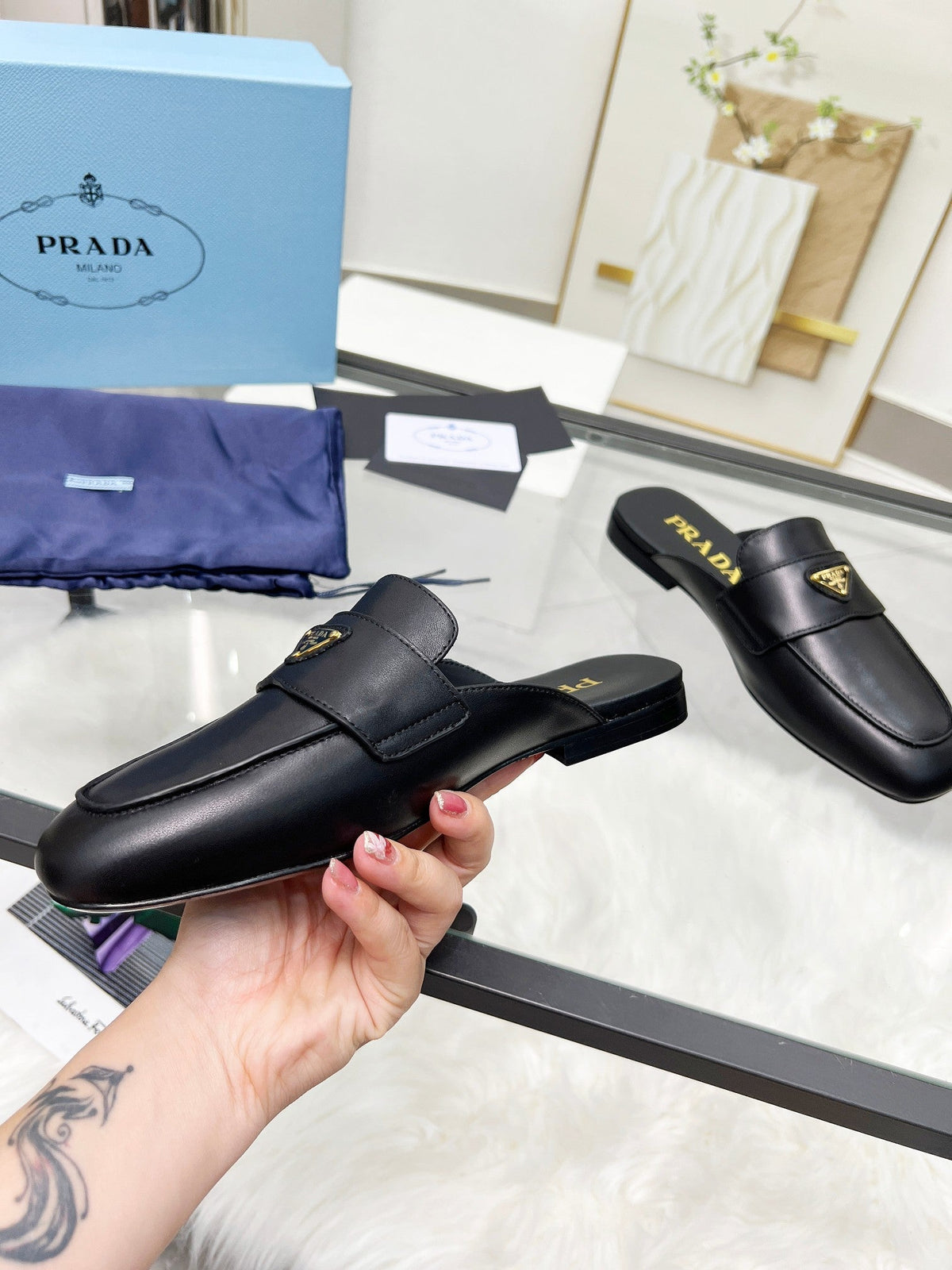 PRADA TRIANGLE LOGO MULES IN BLACK CALFSKIN