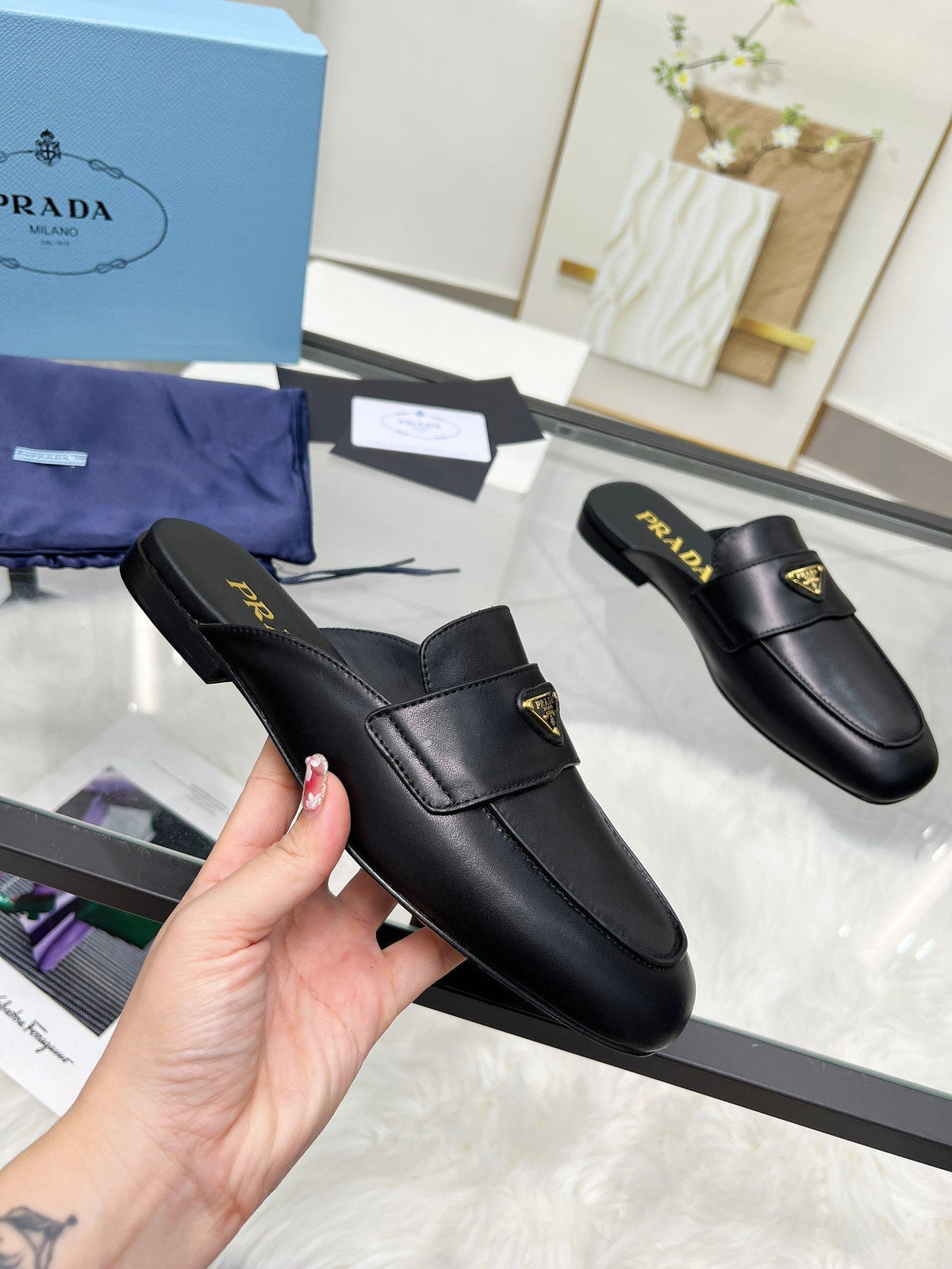 PRADA TRIANGLE LOGO MULES IN BLACK CALFSKIN