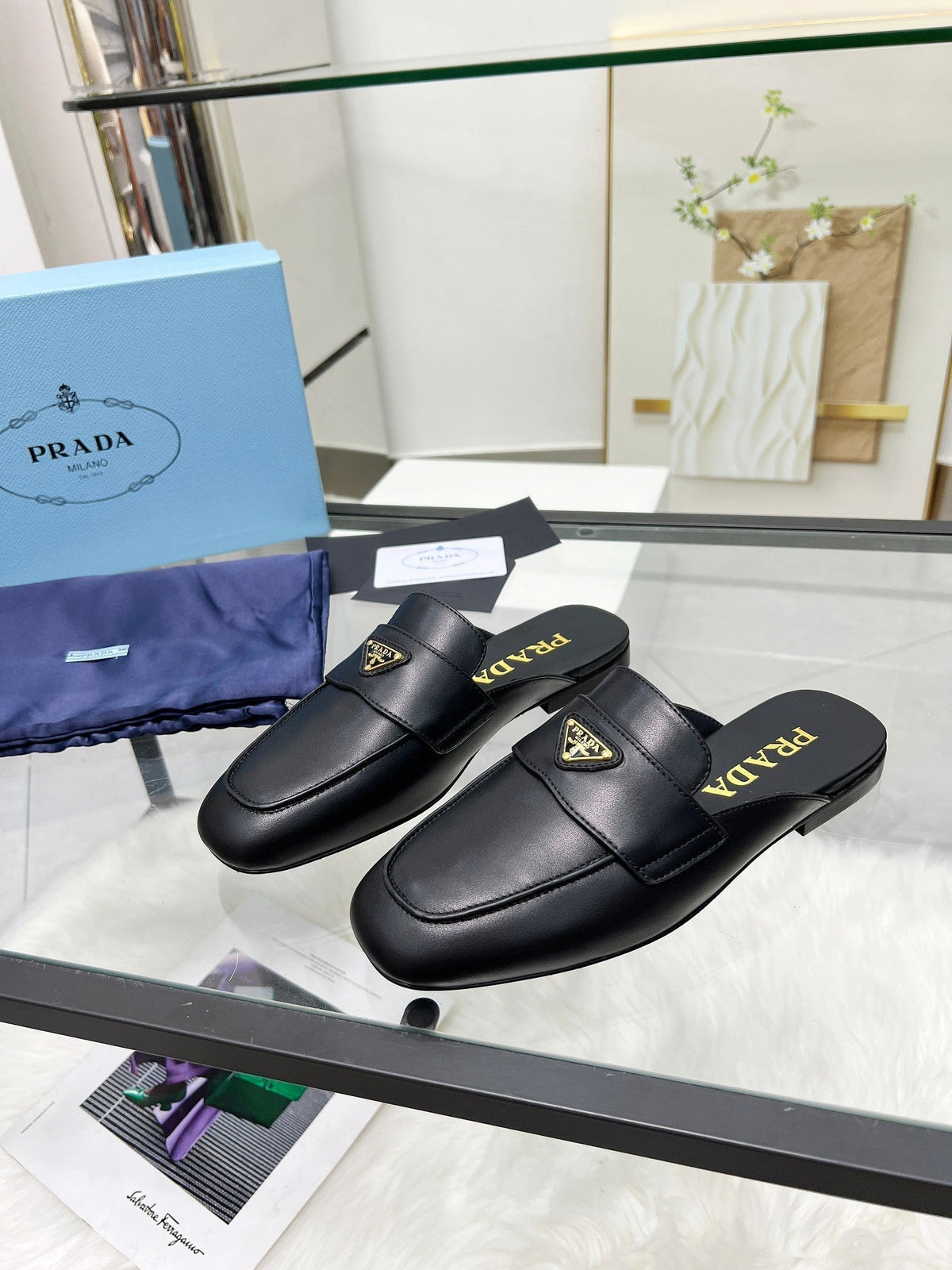 PRADA TRIANGLE LOGO MULES IN BLACK CALFSKIN