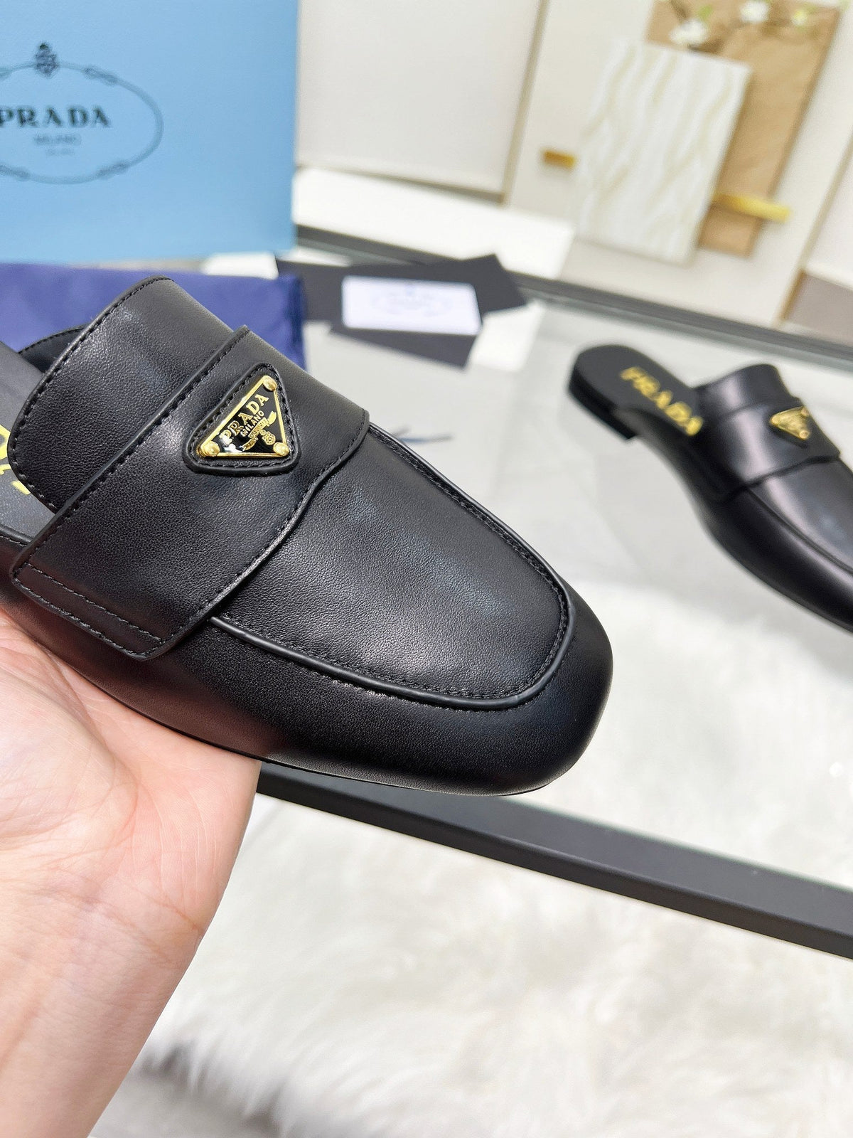 PRADA TRIANGLE LOGO MULES IN BLACK CALFSKIN