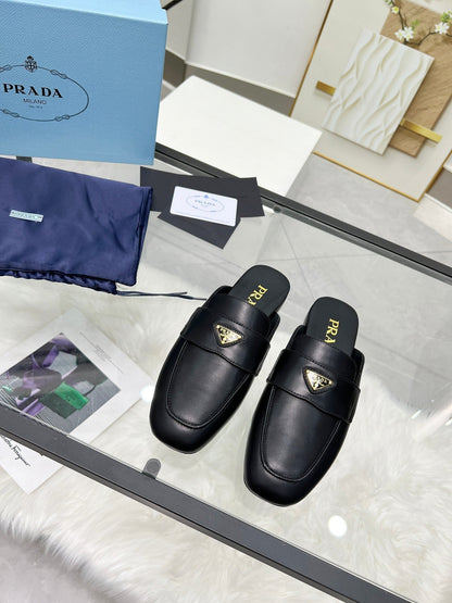 PRADA TRIANGLE LOGO MULES IN BLACK CALFSKIN