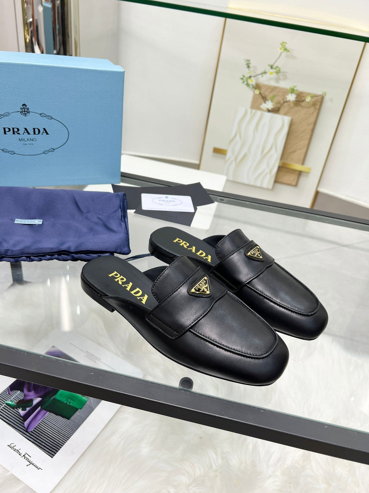 PRADA TRIANGLE LOGO MULES IN BLACK CALFSKIN