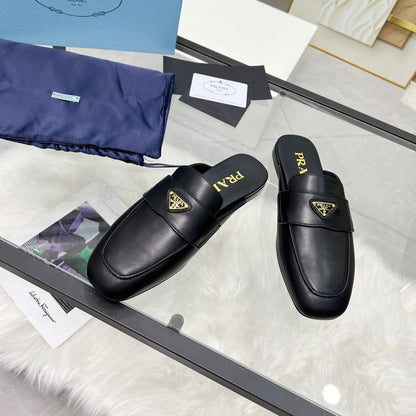 PRADA TRIANGLE LOGO MULES IN BLACK CALFSKIN