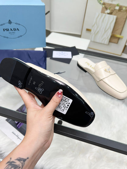 PRADA TRIANGLE LOGO MULES IN WHITE CALFSKIN