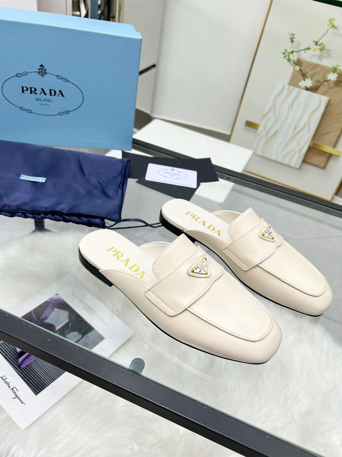 PRADA TRIANGLE LOGO MULES IN WHITE CALFSKIN