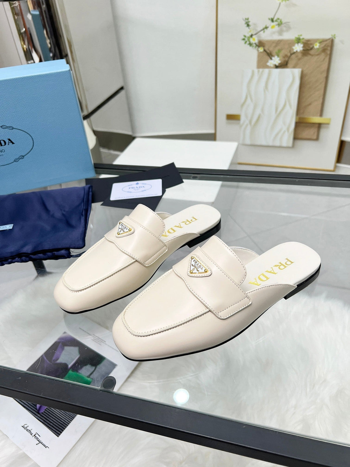 PRADA TRIANGLE LOGO MULES IN WHITE CALFSKIN