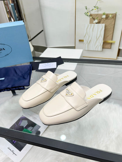 PRADA TRIANGLE LOGO MULES IN WHITE CALFSKIN