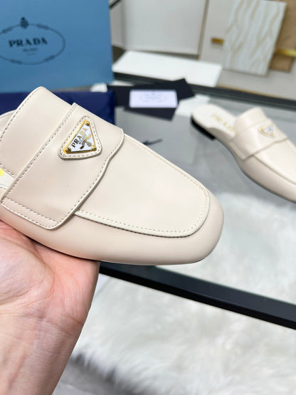 PRADA TRIANGLE LOGO MULES IN WHITE CALFSKIN