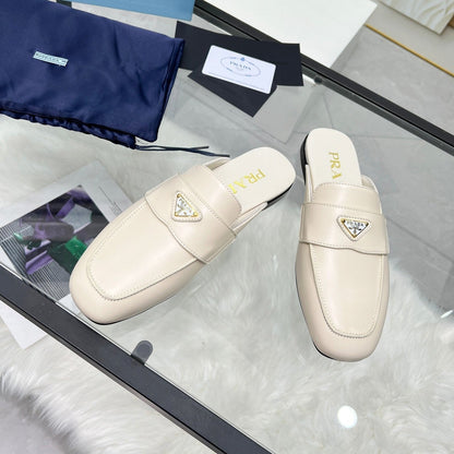 PRADA TRIANGLE LOGO MULES IN WHITE CALFSKIN