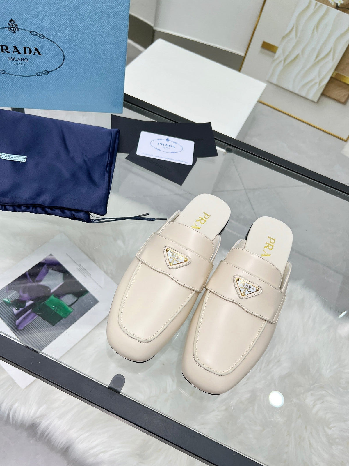 PRADA TRIANGLE LOGO MULES IN WHITE CALFSKIN