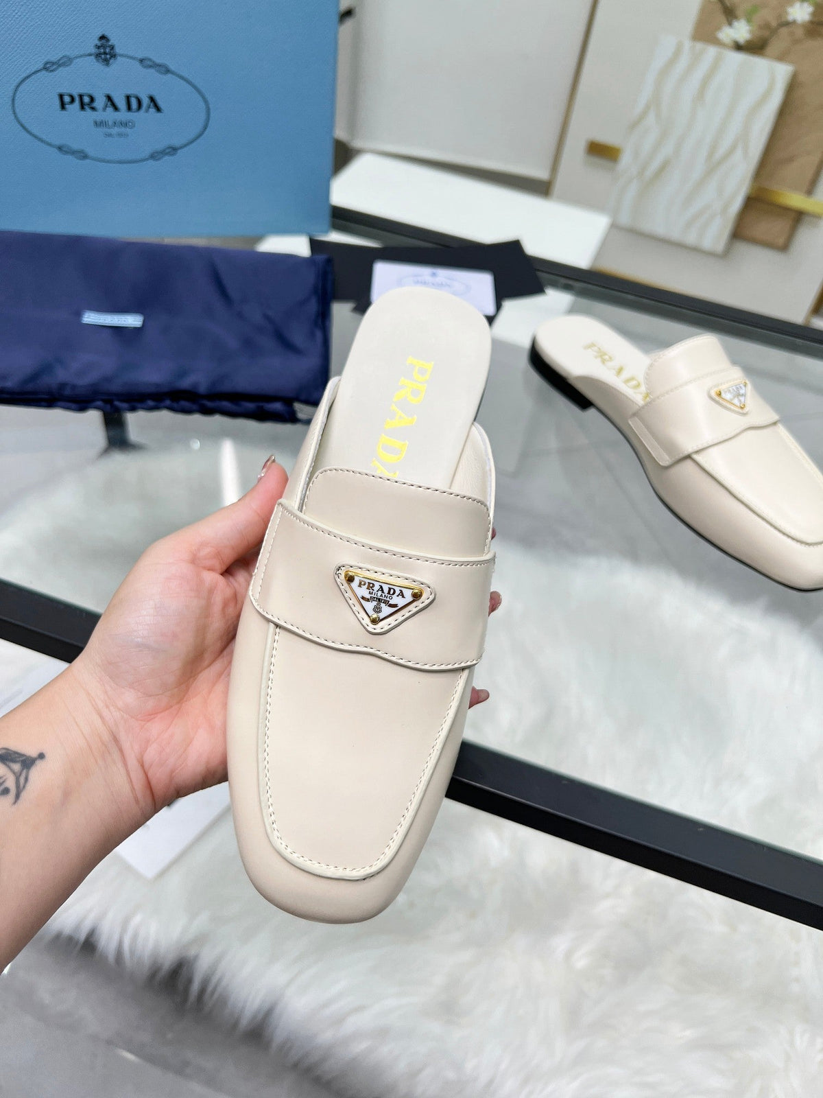 PRADA TRIANGLE LOGO MULES IN WHITE CALFSKIN