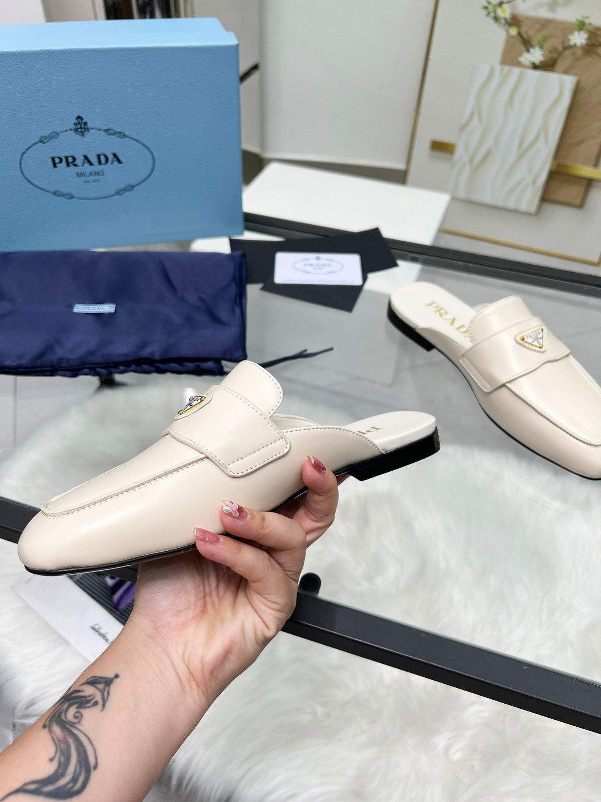 PRADA TRIANGLE LOGO MULES IN WHITE CALFSKIN