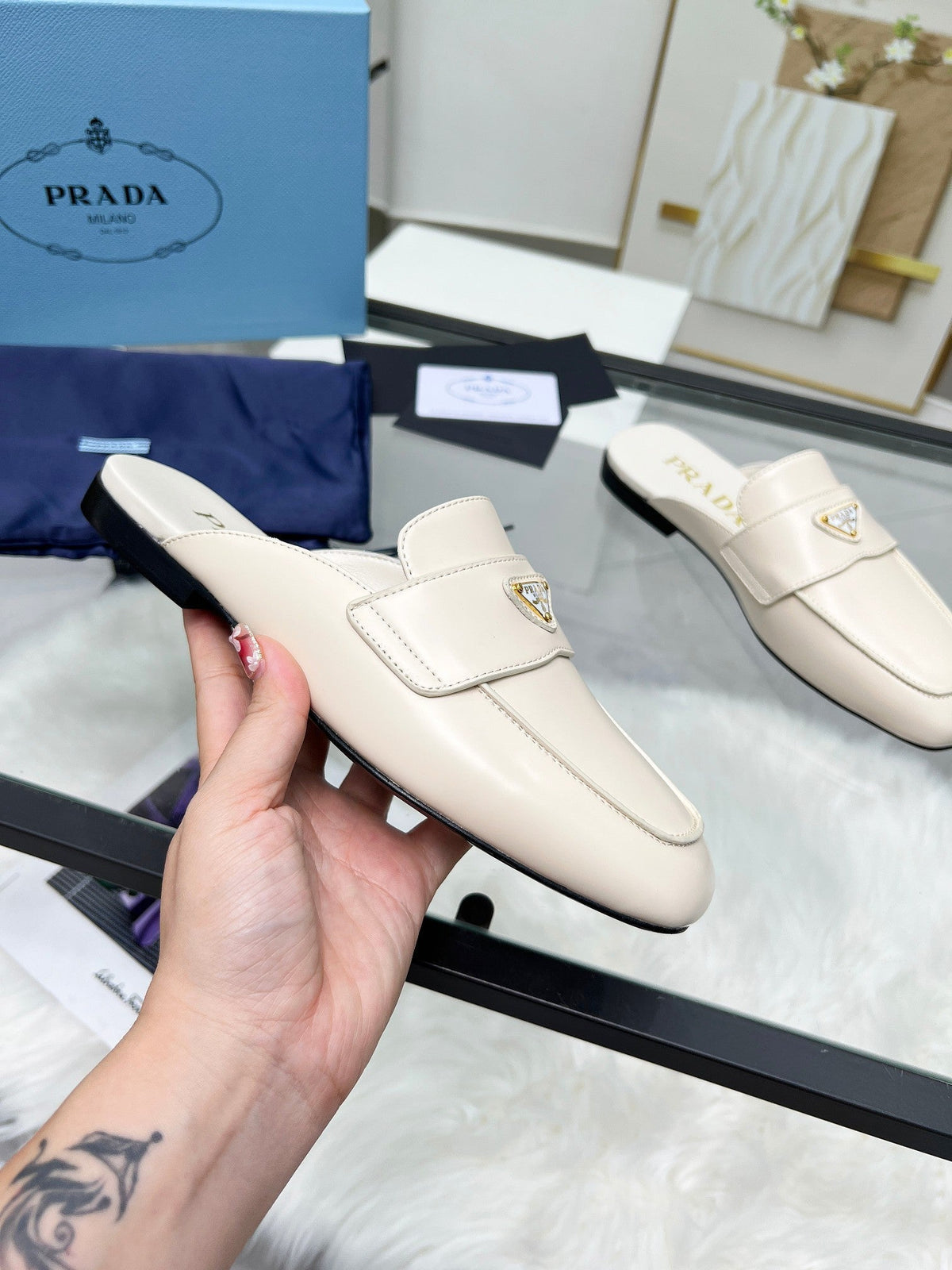 PRADA TRIANGLE LOGO MULES IN WHITE CALFSKIN