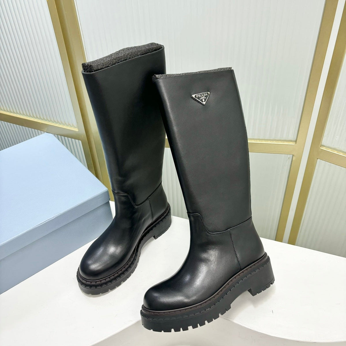 PRADA KNEE BOOTS WITH TRIANGLE LOGO IN BLACK CALFSKIN