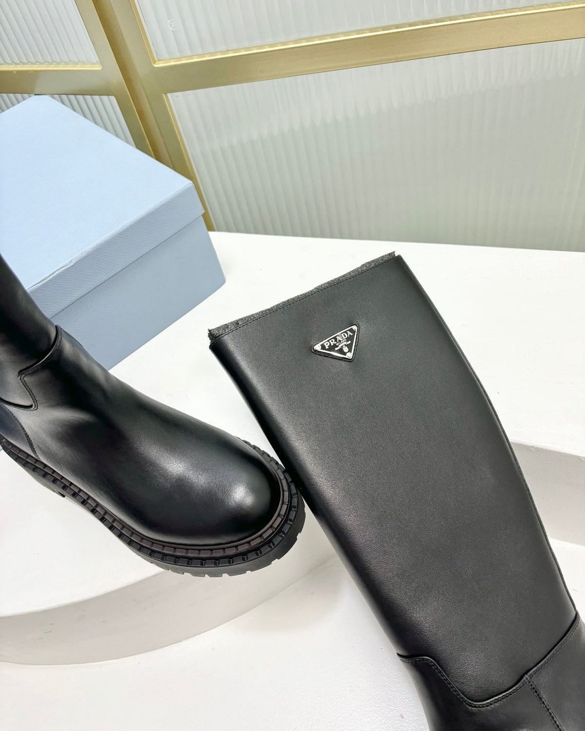 PRADA KNEE BOOTS WITH TRIANGLE LOGO IN BLACK CALFSKIN