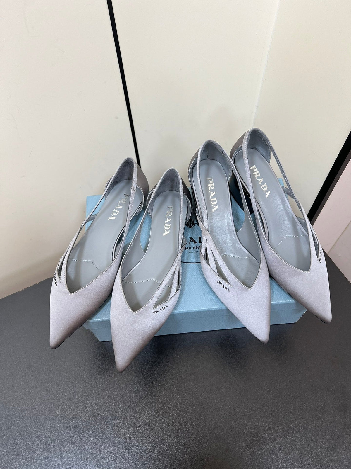 PRADA CUT-OUT BALLERINAS IN WARM GRAY SATIN