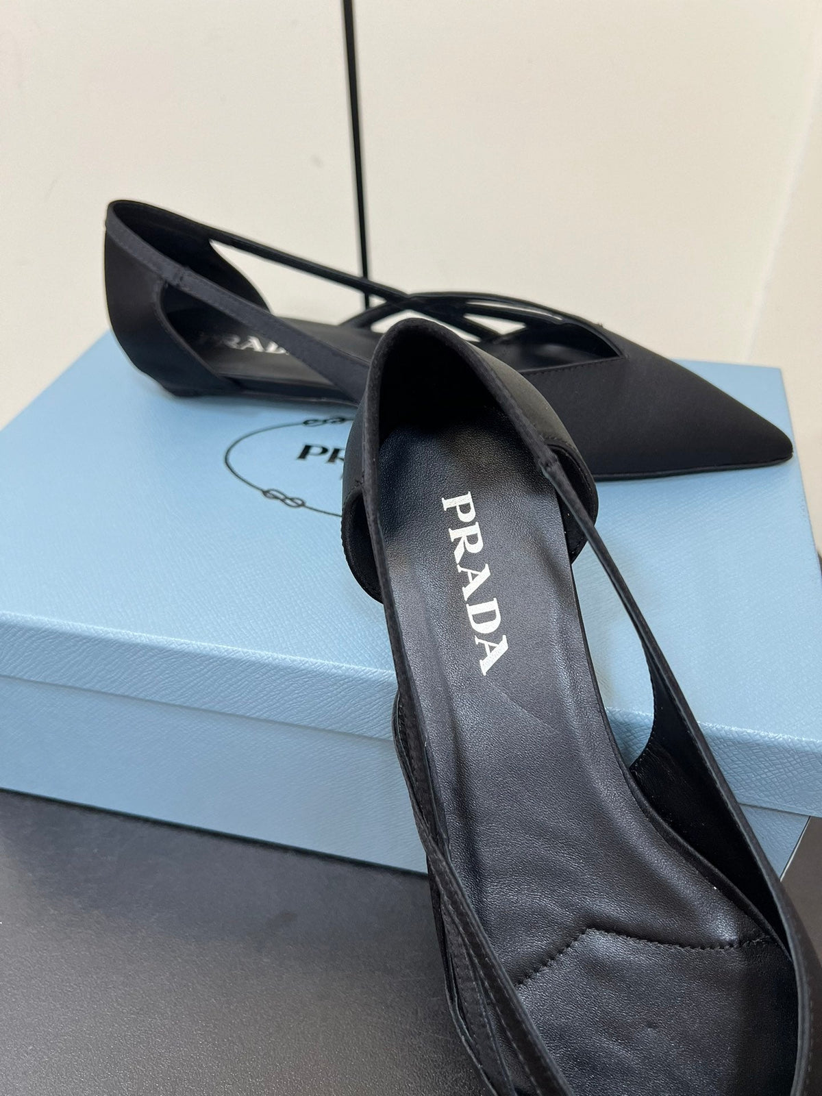 PRADA CUT-OUT BALLERINAS IN BLACK SATIN