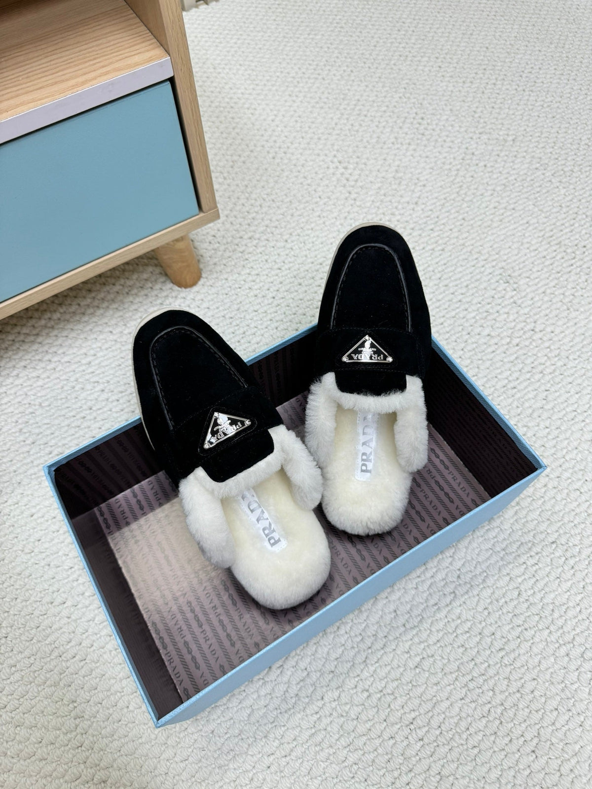 PRADA TRIANGLE LOGO FLATS IN BLACK SUEDE AND FUR LINING