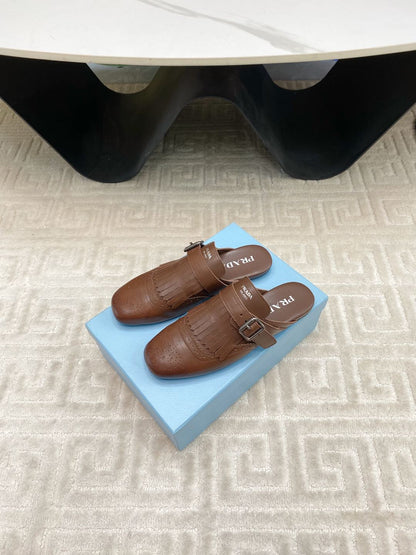 PRADA TASSEL MULES IN RUSSET BROWN LAMBSKIN