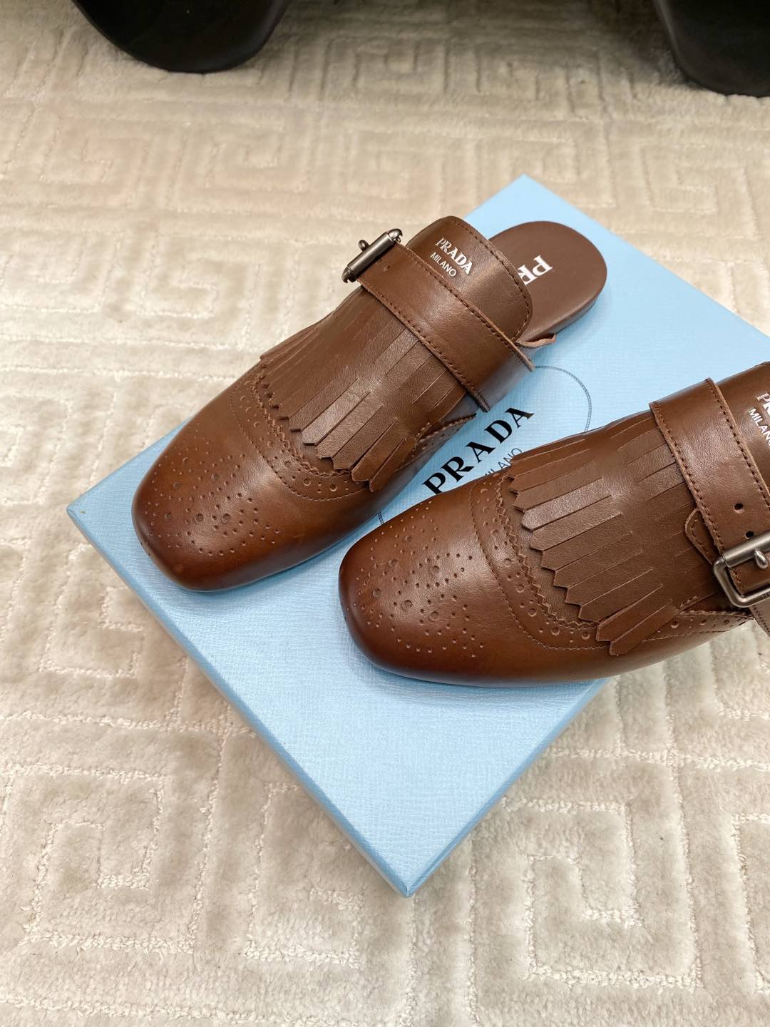 PRADA TASSEL MULES IN RUSSET BROWN LAMBSKIN
