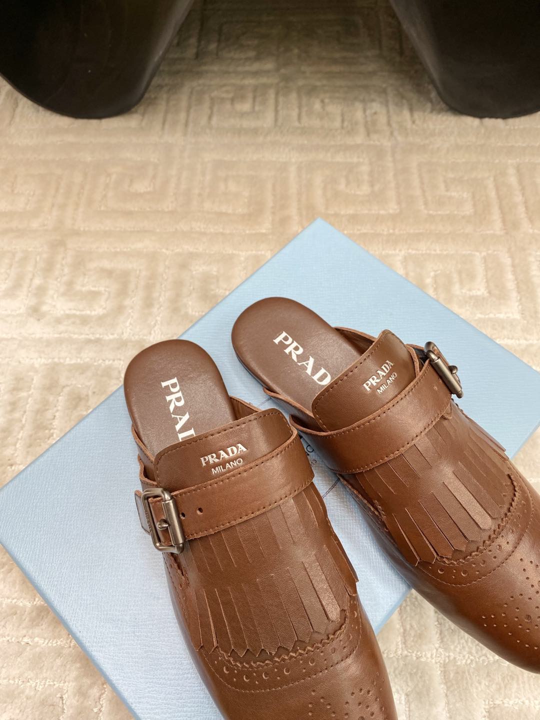 PRADA TASSEL MULES IN RUSSET BROWN LAMBSKIN