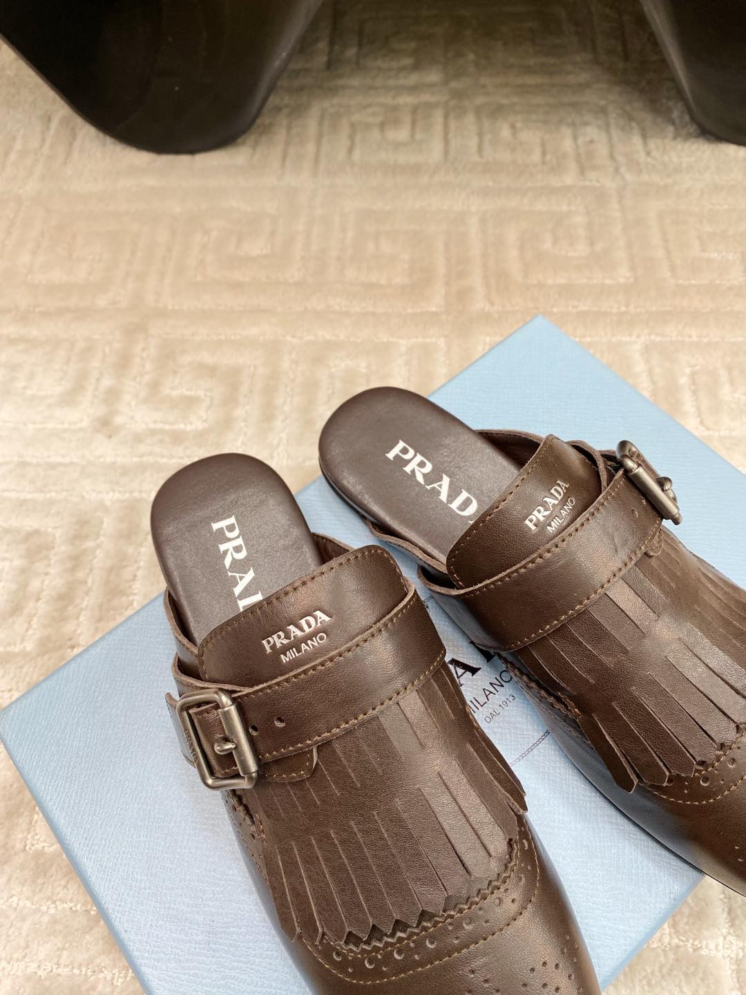 PRADA TASSEL MULES IN WALNUT BROWN LAMBSKIN