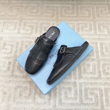 PRADA TASSEL MULES IN BLACK LAMBSKIN