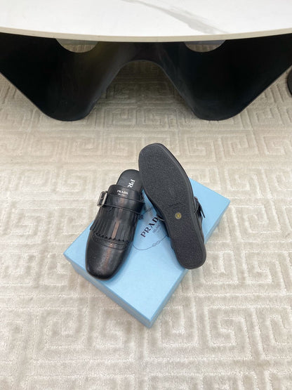 PRADA TASSEL MULES IN BLACK LAMBSKIN