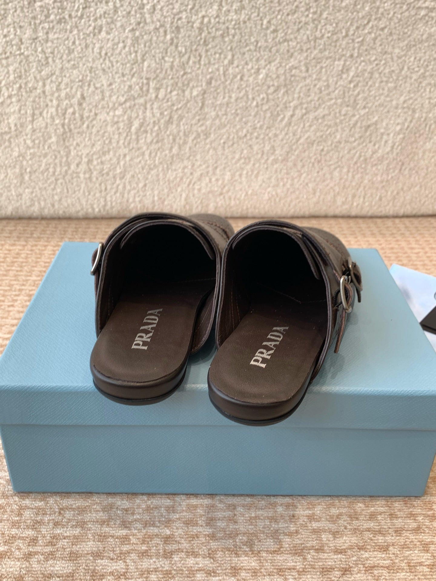 PRADA DOUBLE MONK MULES IN WALNUT BROWN CALFSKIN