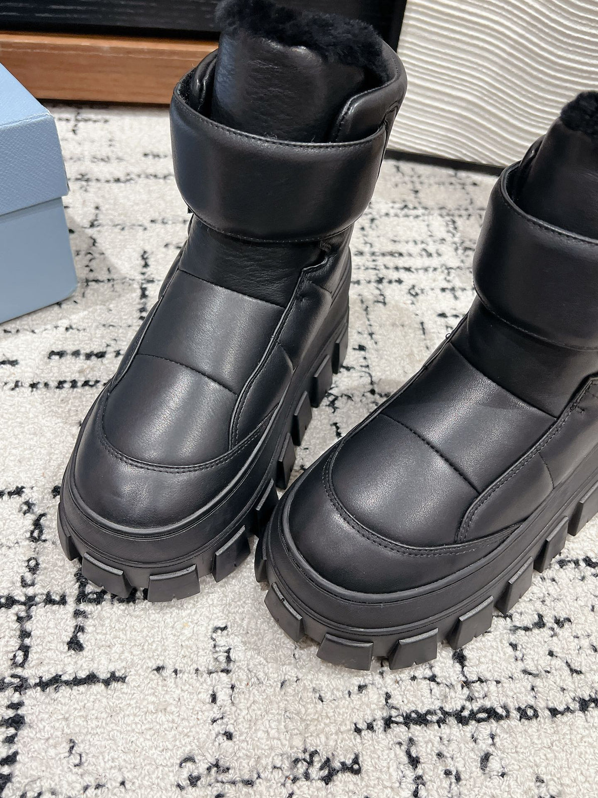 PRADA MONOLITH ANKLE BOOTS WITH STRAP IN BLACK CALFSKIN AND FLEECE LINING