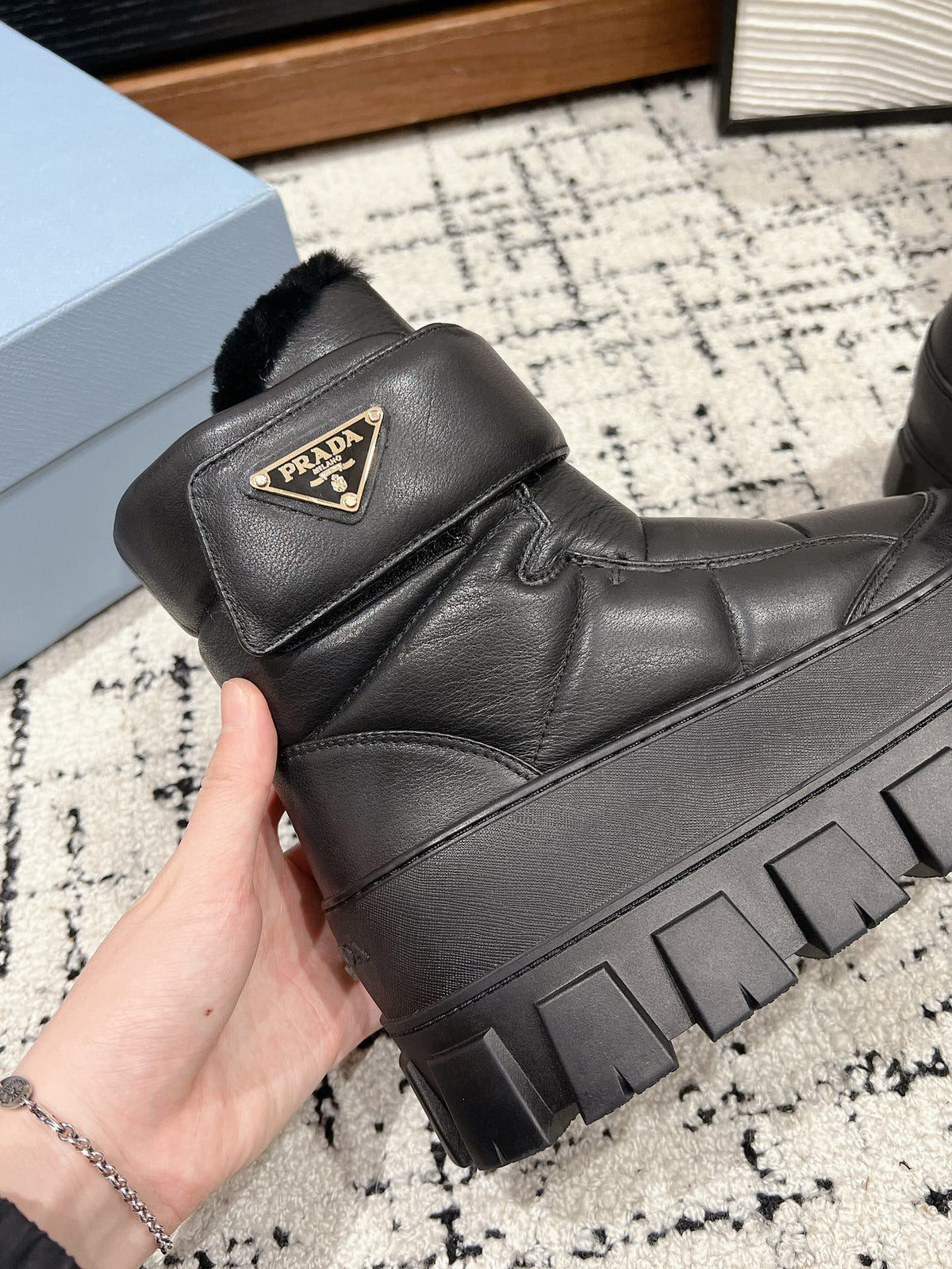 PRADA MONOLITH ANKLE BOOTS WITH STRAP IN BLACK CALFSKIN AND FLEECE LINING