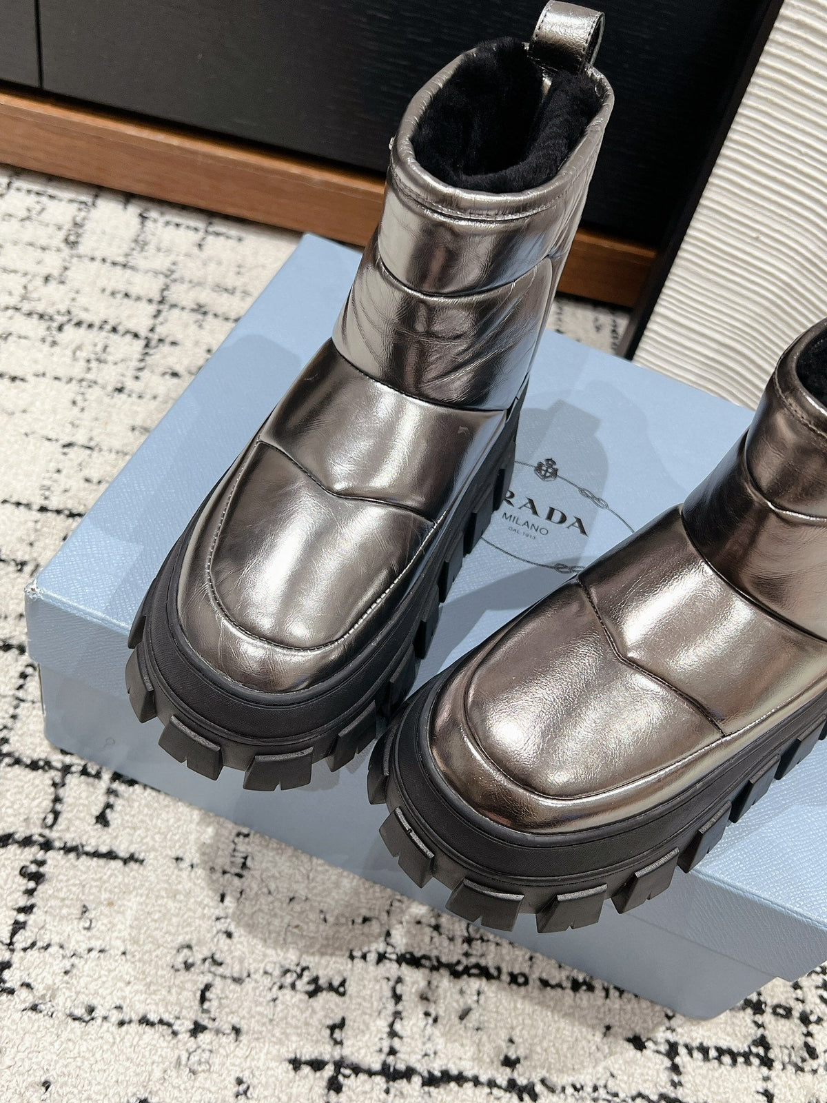 PRADA MONOLITH ANKLE BOOTS IN METALLIC GRAY CALFSKIN AND LAMB FUR LINING