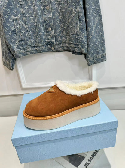PRADA TRIANGLE LOGO MULES IN BRONZE BROWN SUEDE AND SHEARLING LINING