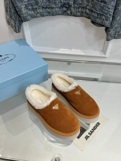 PRADA TRIANGLE LOGO MULES IN BRONZE BROWN SUEDE AND SHEARLING LINING